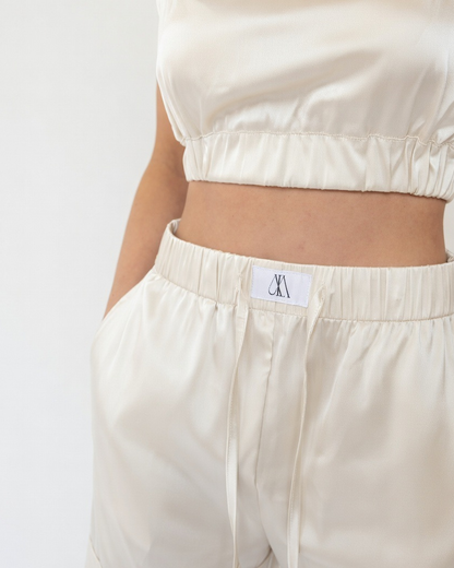 model wearing yellow satin pyjamas